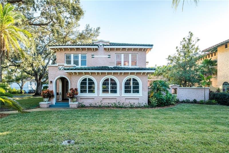 Situated on a beautiful corner lot with grand oak 