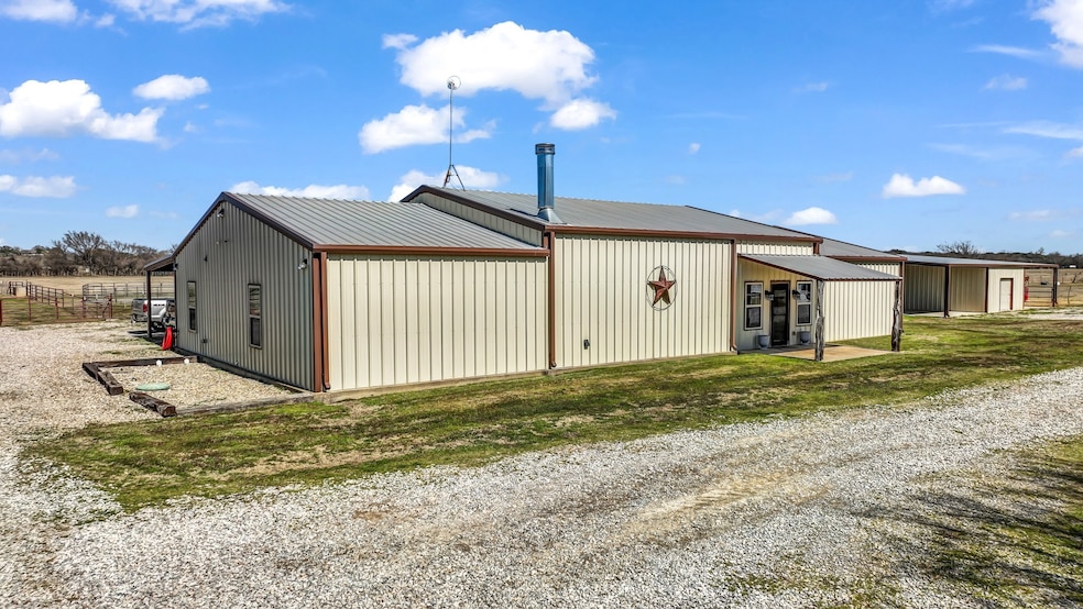View of side of property featuring a metal roof and a pole building
