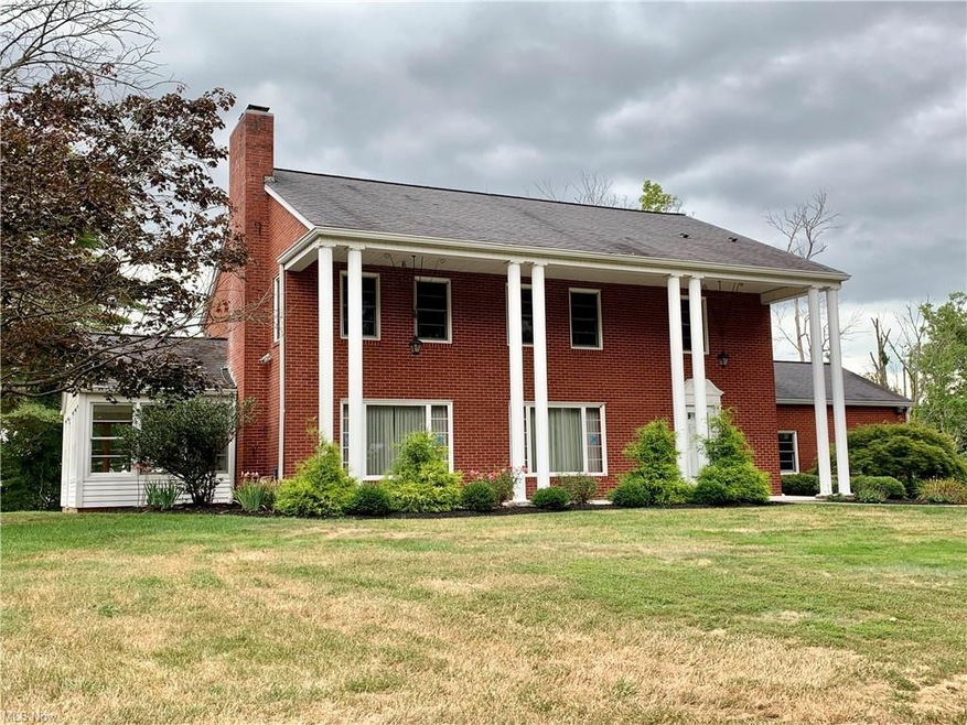 Stately, brick colonial style home on 7 private ac