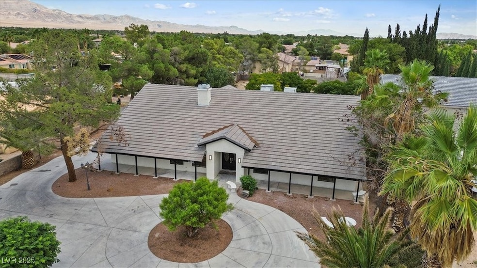 View of front of house with a mountain view, a tile roof, and a chimney