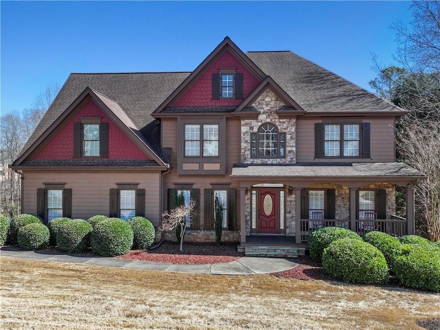 Craftsman house featuring stone siding, a porch, and roof with shingles
