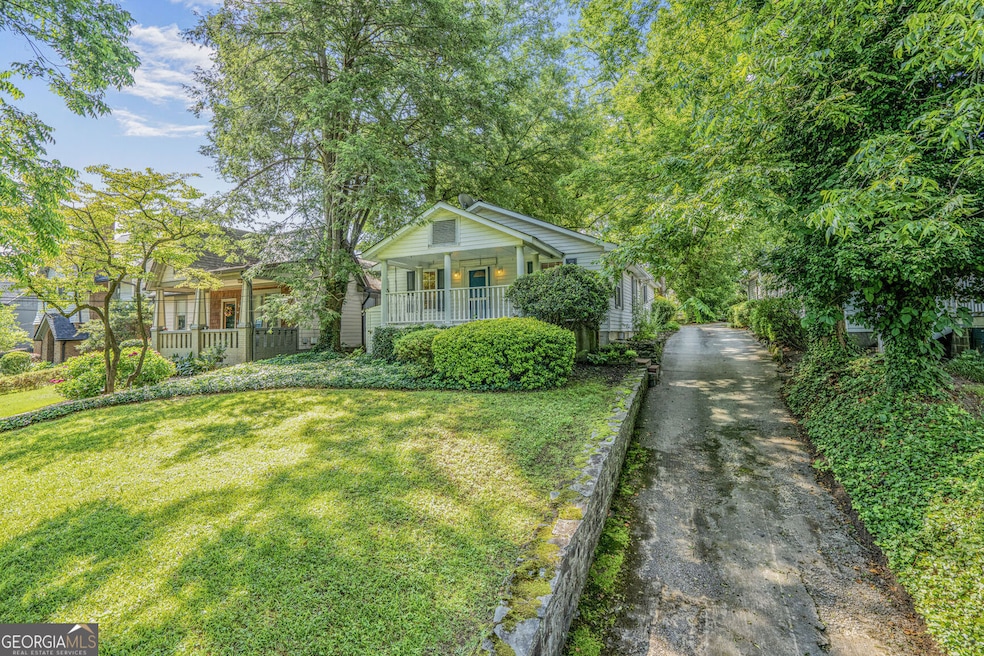 View of front house from street showcasing the beautiful green and serene setting.