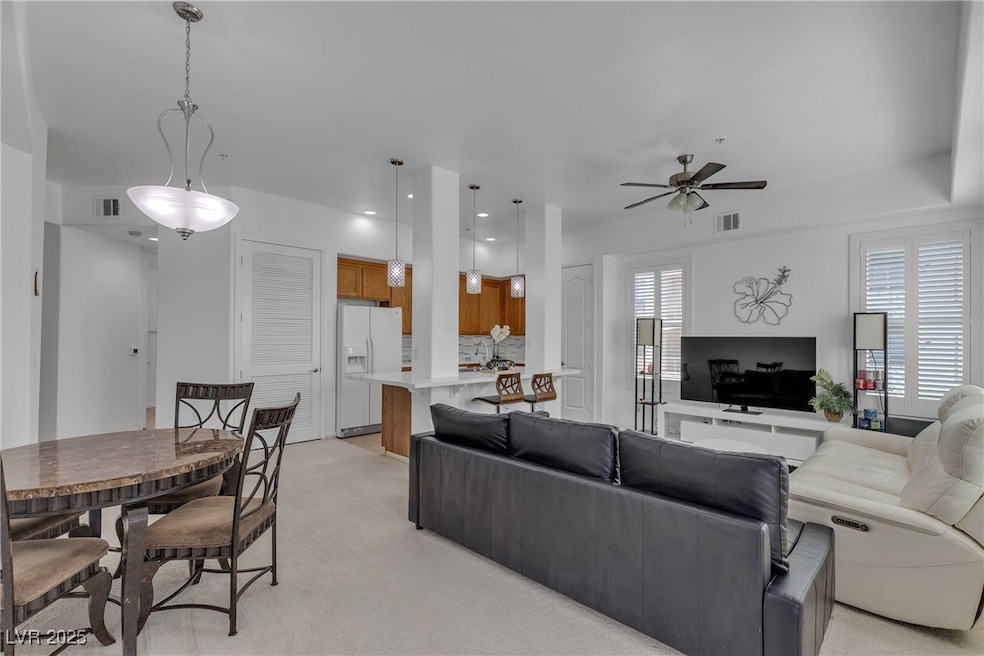 Living area with light carpet, visible vents, and