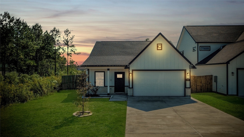A cozy evening view showing the front exterior lit up, highlighting the home's warm and inviting curb appeal at dusk.