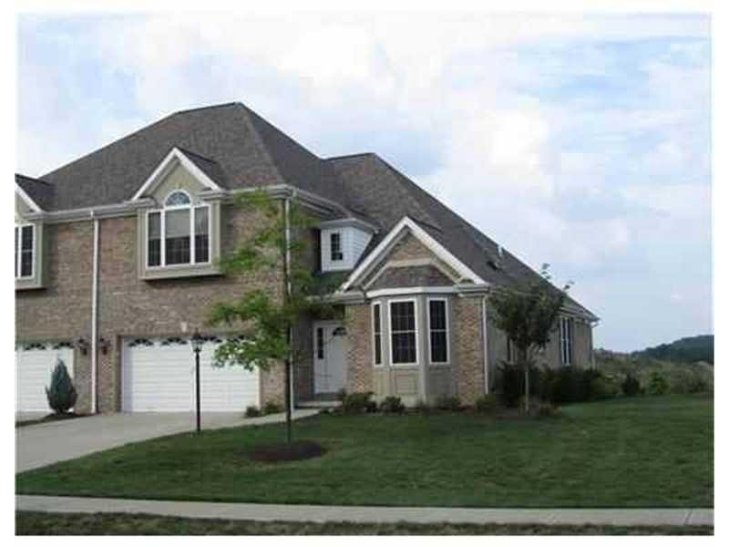 Exterior Front. Brick unit with flat driveway & fl