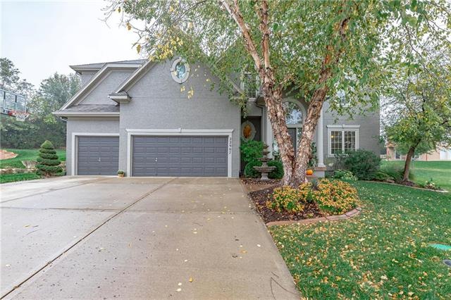 Flat driveway, 3 car garage, and beautiful landsca