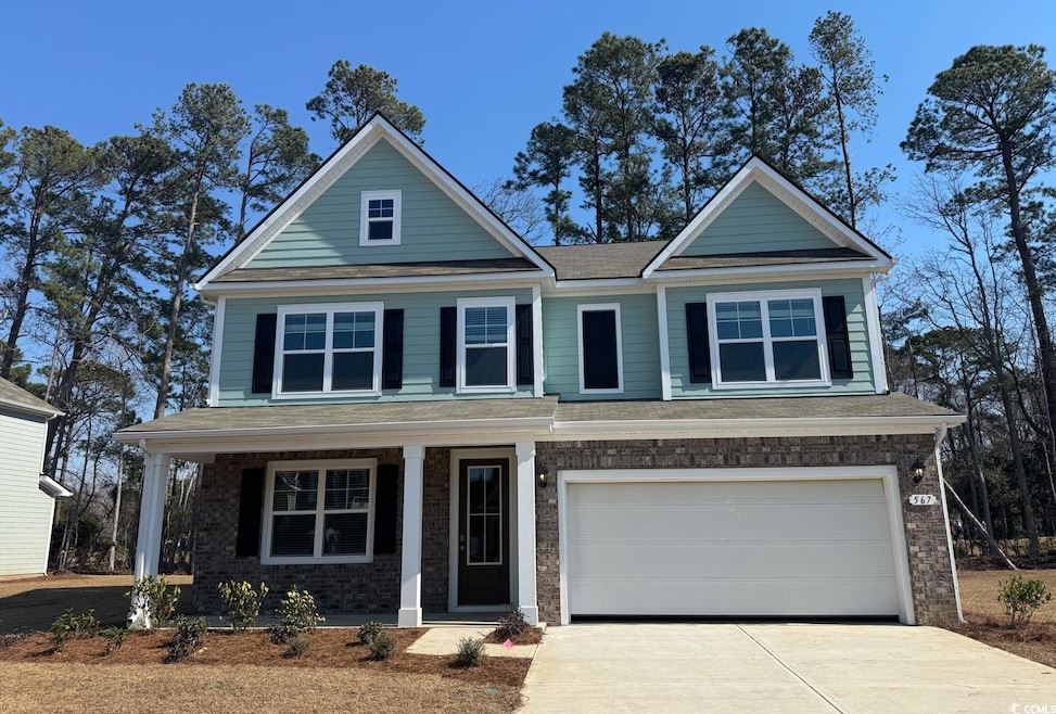 View of front of home with brick siding, a porch, 