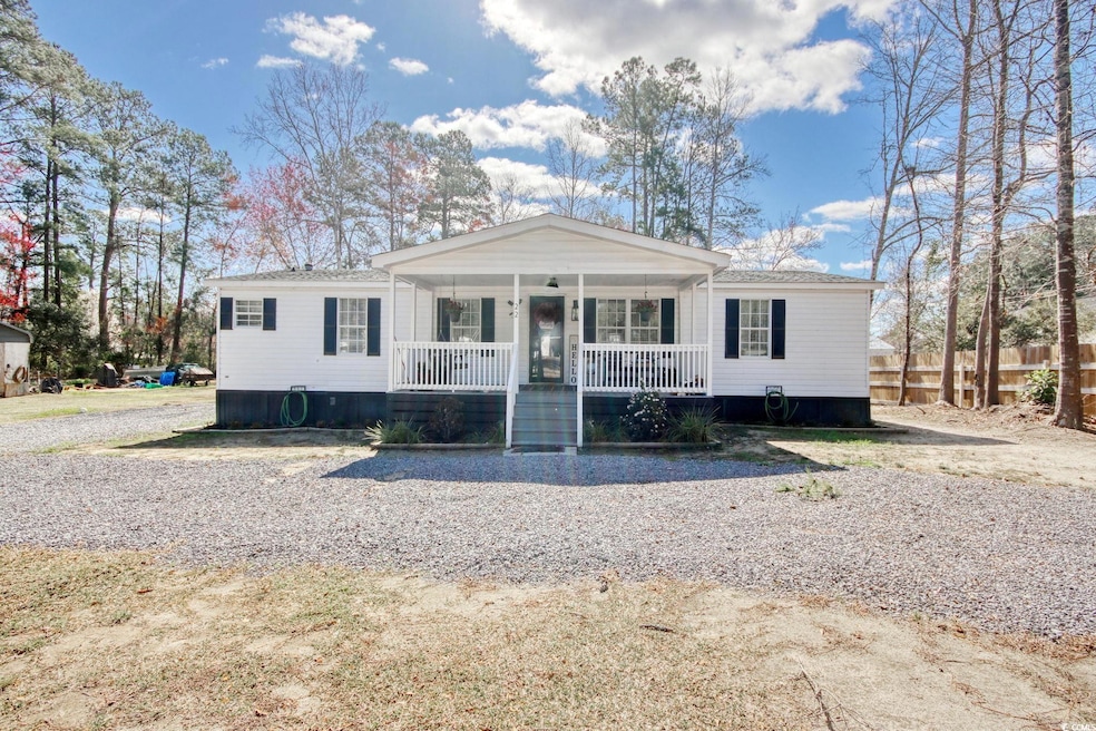 View of front of house with covered porch and fenc