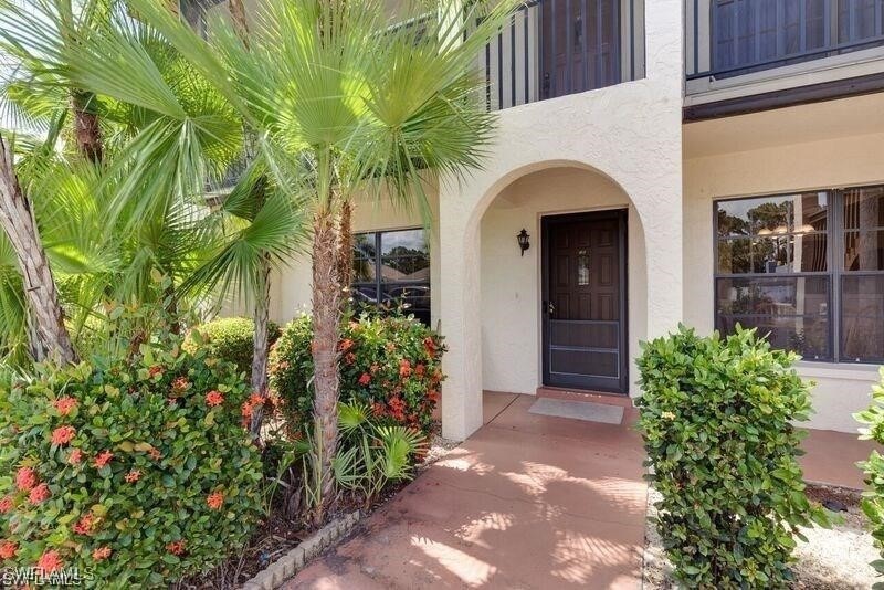 Property entrance featuring stucco siding