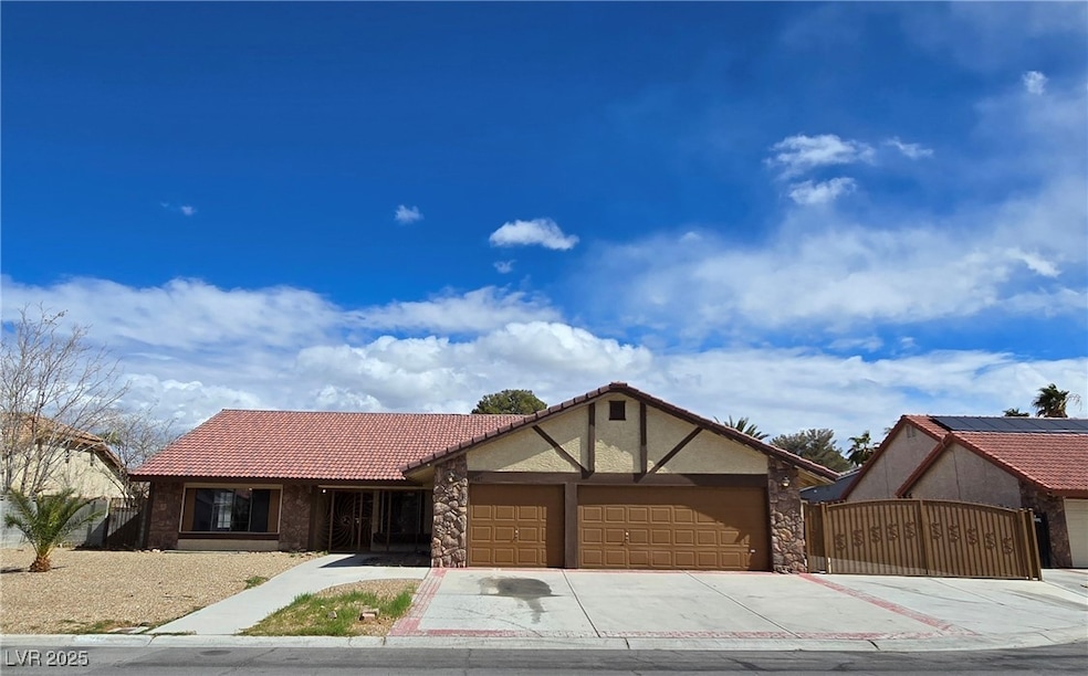 Ranch-style home with a tiled roof, concrete drive