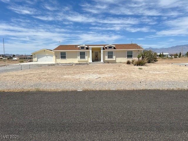 View of front facade with a mountain view and a ga