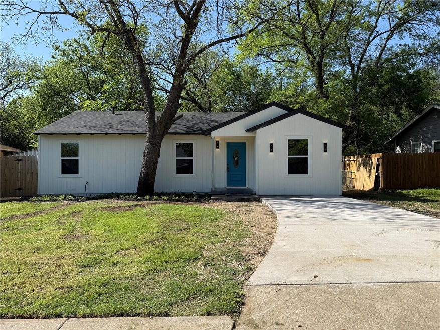 Ranch-style home featuring a front yard, driveway,