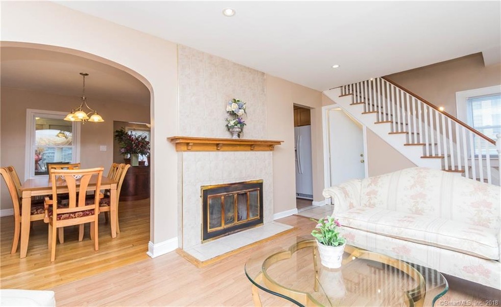 Living room with wood burning fireplace and hardwo