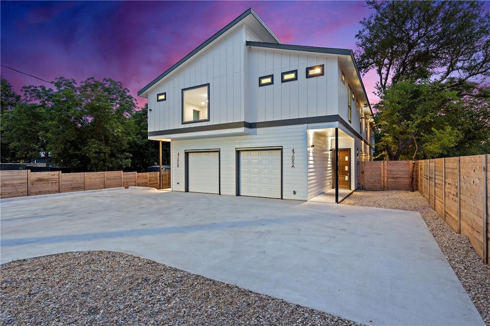 View of side of home with concrete driveway, fenc