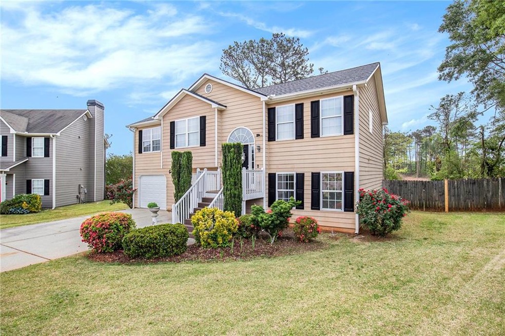 Bi-level home with a garage and a front lawn