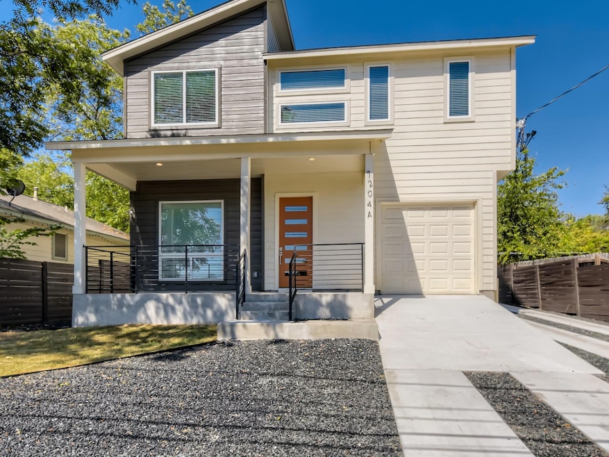 View of front facade with covered porch, fence, a