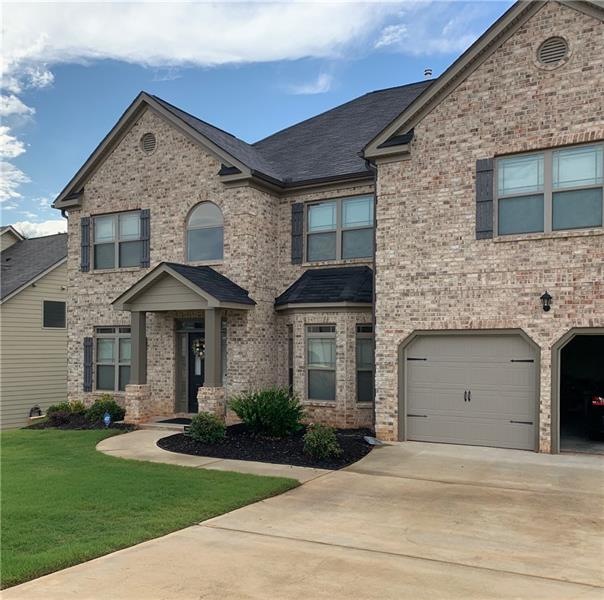 Brick Front with treated lawn.