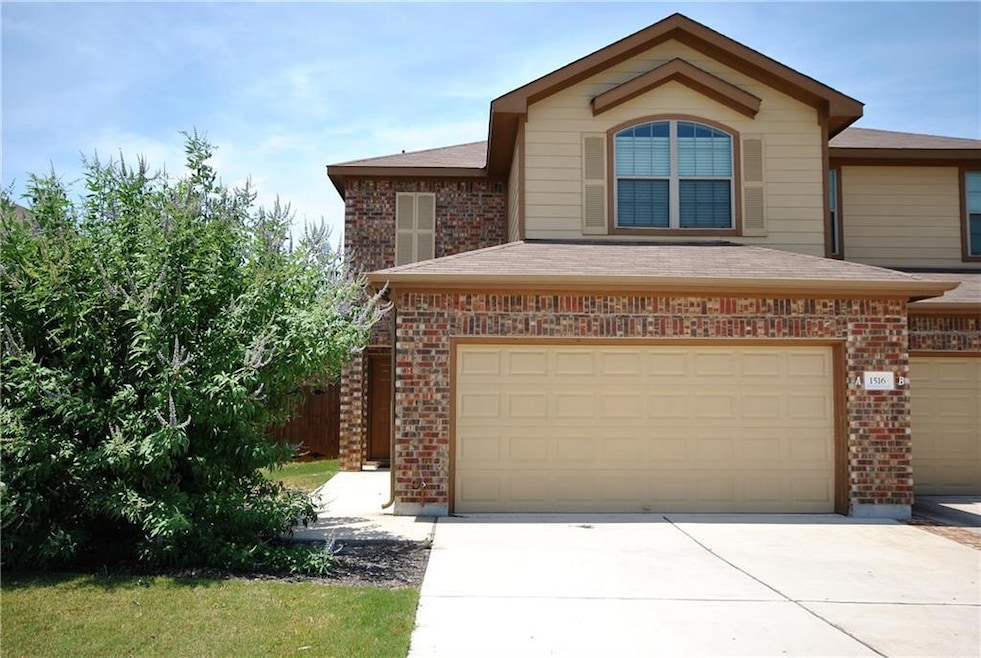 View of front of house with brick siding, a garag