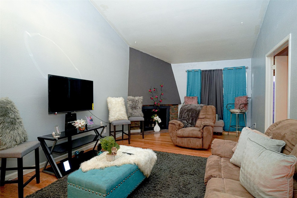 A spacious living area with a wood burning firepla