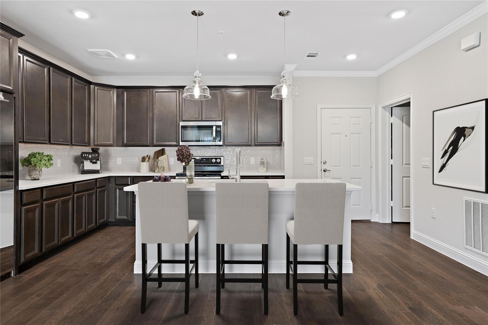 The kitchen has beautiful dark cabinet and white q