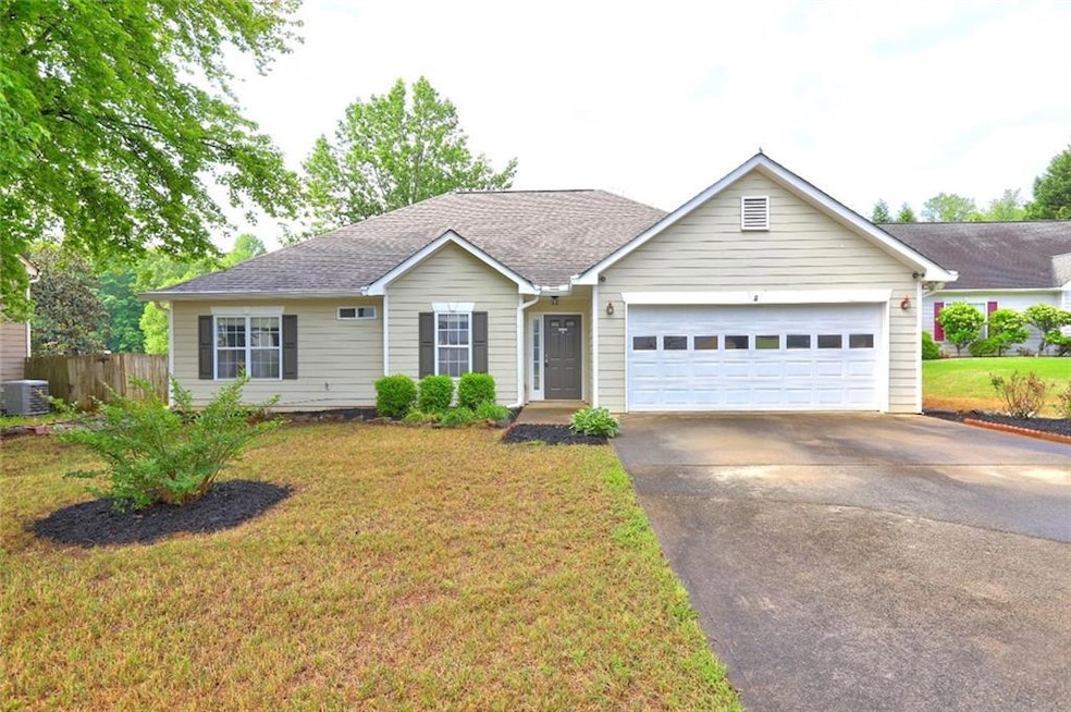 Single story home with a garage, central AC unit, 