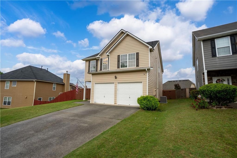 View of front of house with driveway, a garage, an