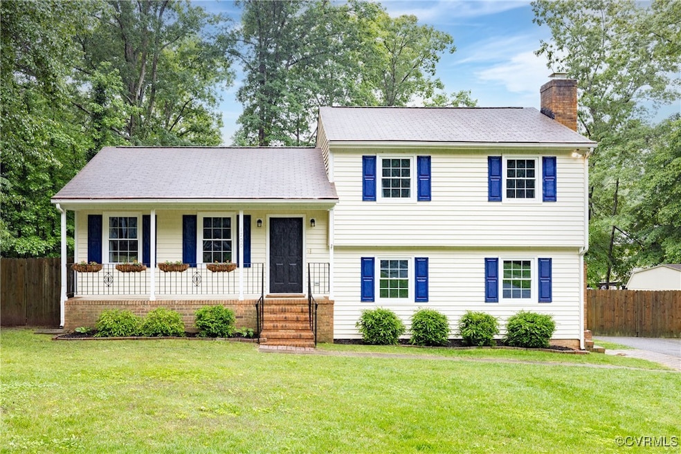 Tri-level home featuring a covered porch