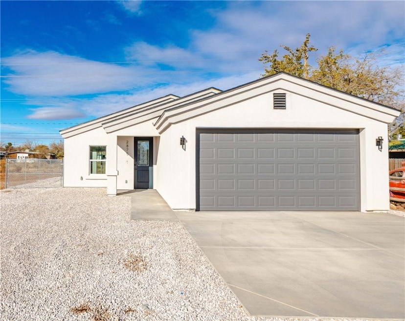 Ranch-style house with stucco siding, concrete dri