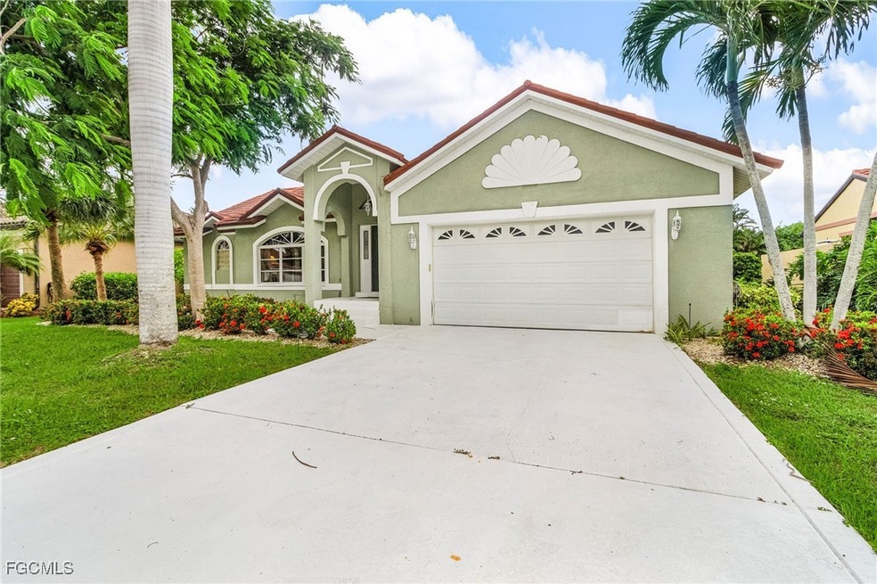 View of front of property with stucco siding, concrete driveway, an attached garage, and a front yard