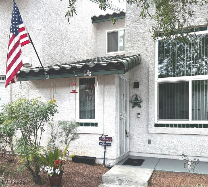 Front door to property, featuring green tiled roof