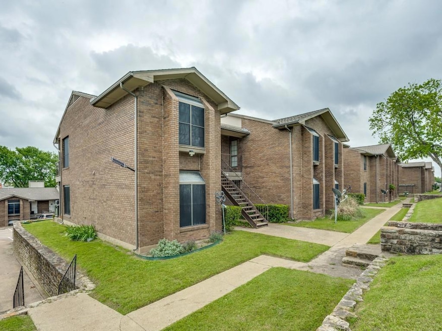 View of side of home with brick siding, a lawn, an