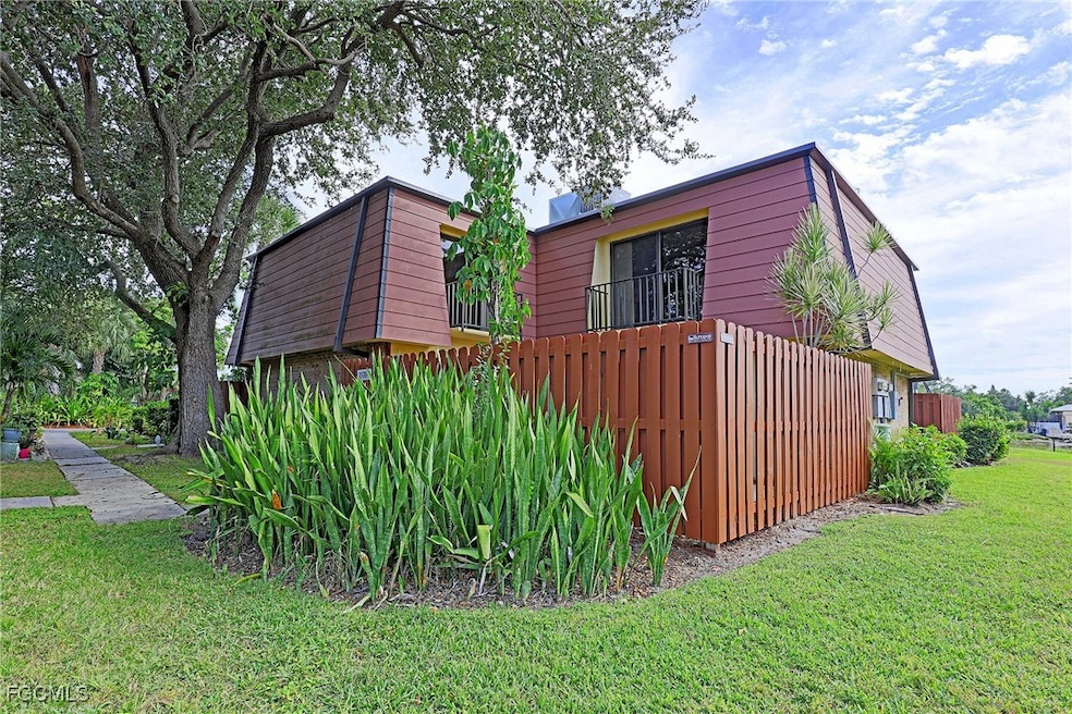 View of side of home featuring mansard roof