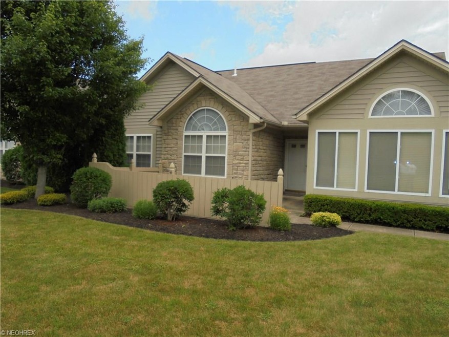 Street view with stone and vinyl siding.