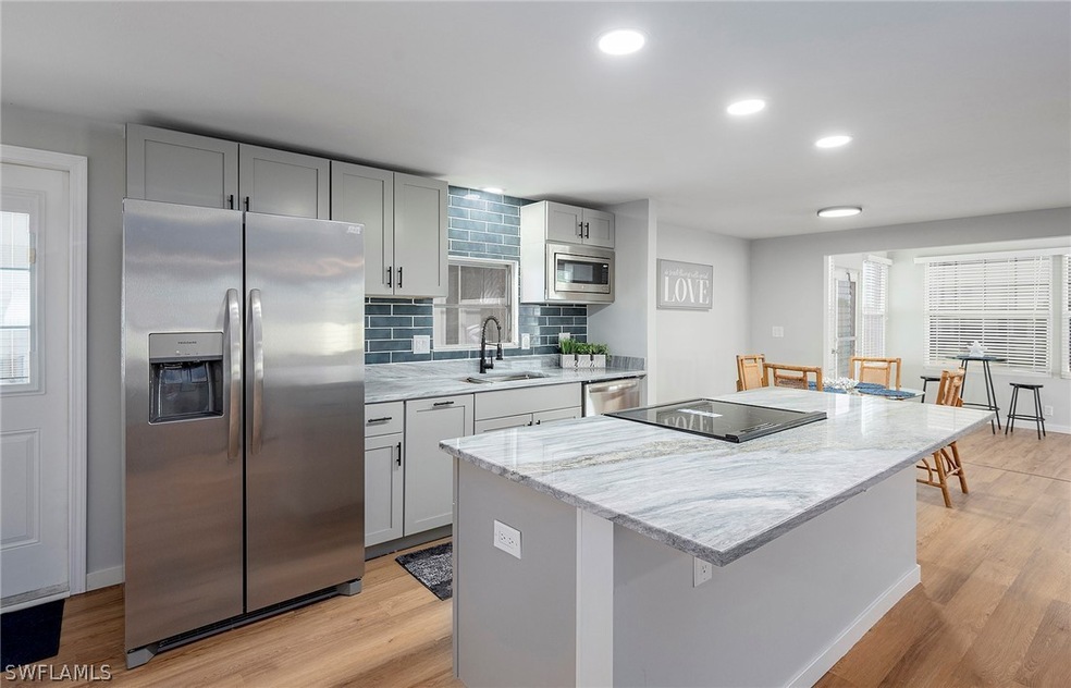 Kitchen with tasteful backsplash, stainless steel