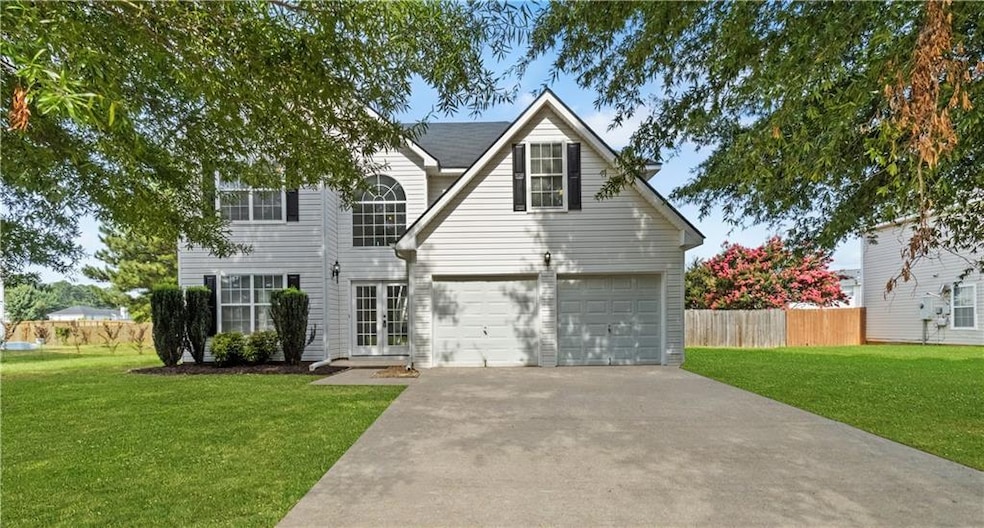 Traditional-style home with driveway and an attached garage