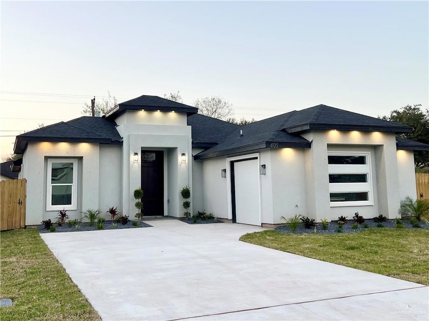 Prairie-style home featuring a garage and a front yard