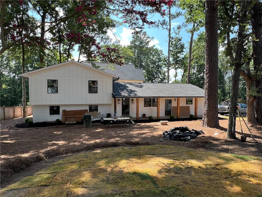 Rear view of house featuring brick siding