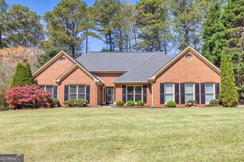 Single story home featuring brick siding, roof wit