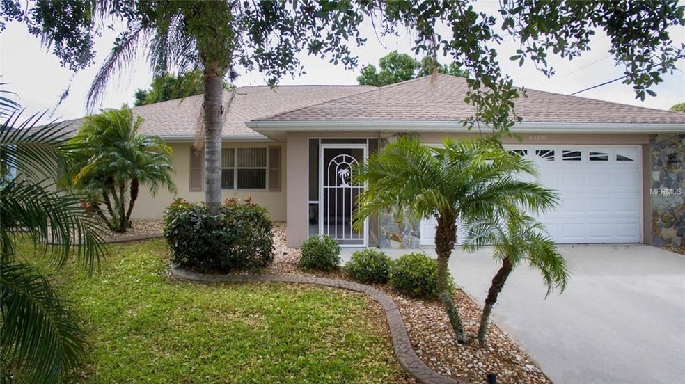 Front of home with curbed flower beds and screened