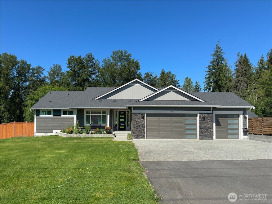 Long private driveway with RV parking plus 3 car garage