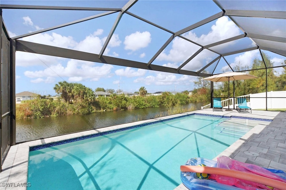 View of swimming pool with a patio, a water view,