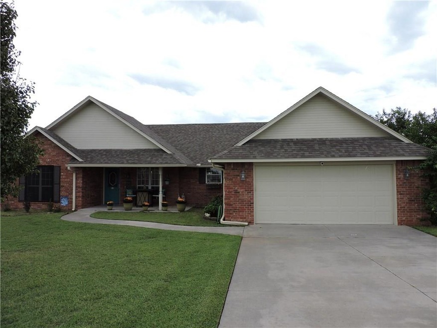 West facing covered front porch with driveway made