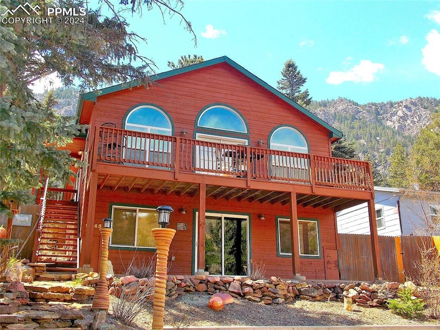 Front of house with deck & featuring a mountain vi