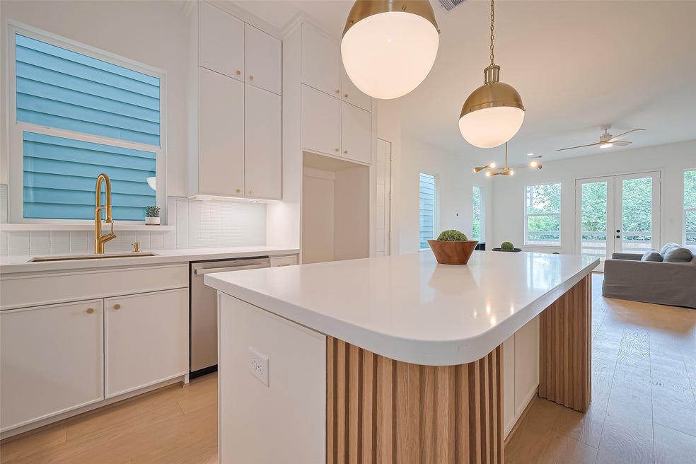 View of the kitchen showing the breakfast bar seat