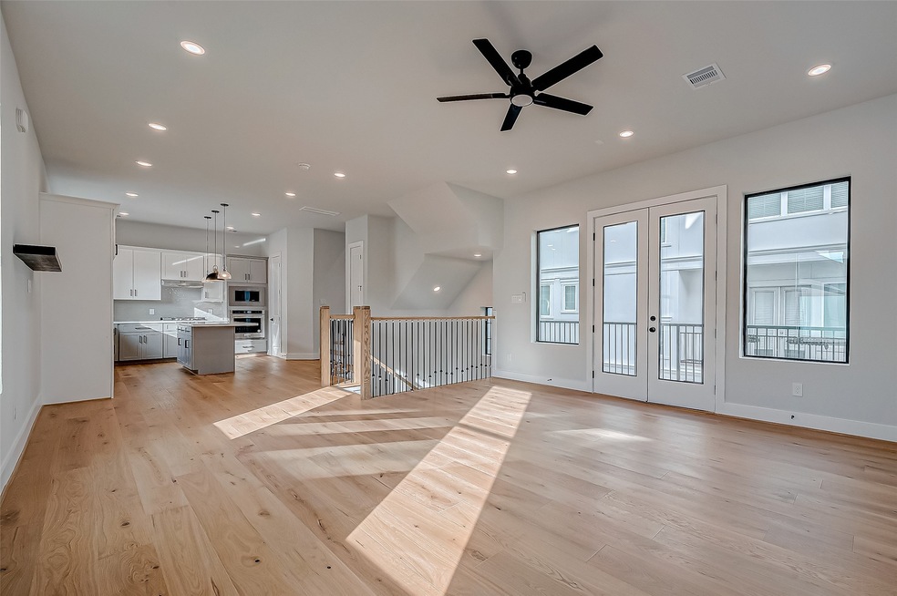 A spacious, open-concept living area with hardwood