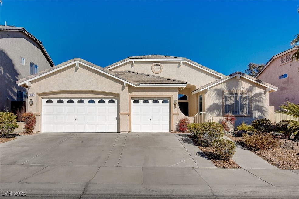 Ranch-style house with stucco siding, an attached