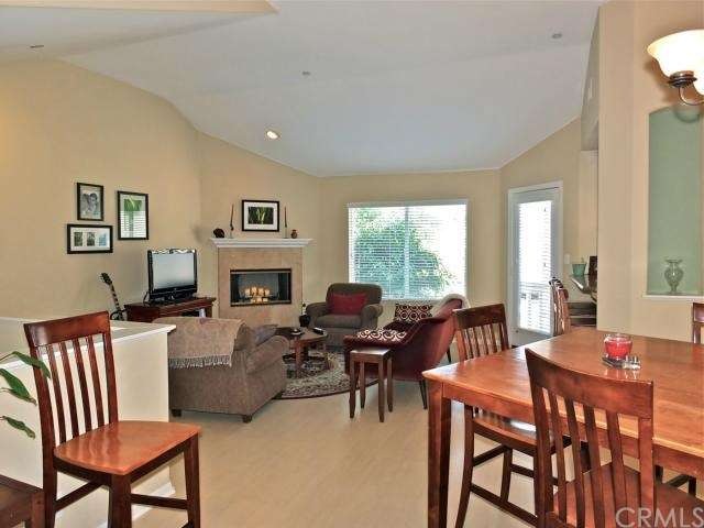 Fireplace in living room and open to kitchen and d