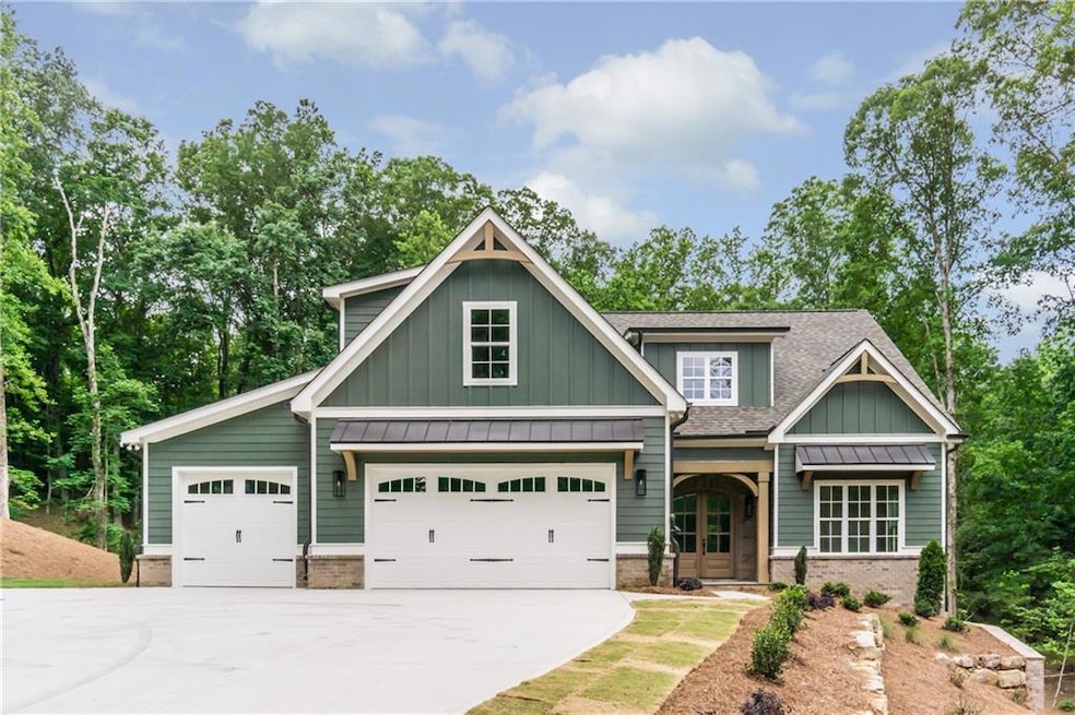 Craftsman inspired home featuring board and batten siding, driveway, roof with shingles, an attached garage, and brick siding