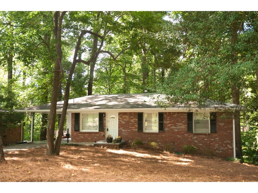 Brick home, front of house with carport and drivew