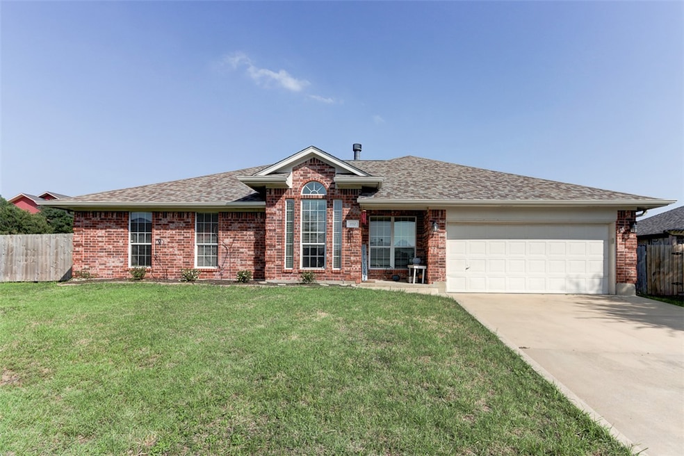 Ranch-style house featuring fence, a garage, concr
